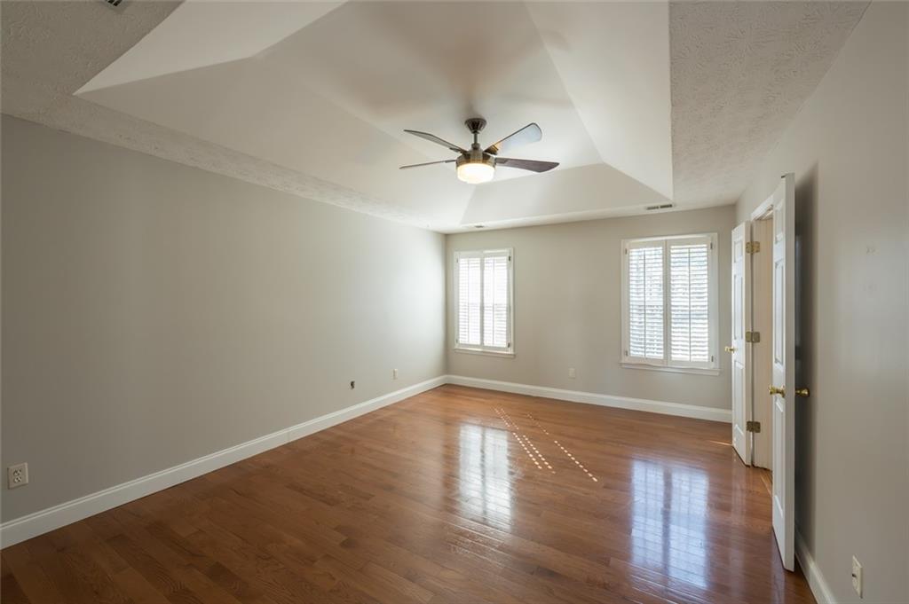 3789 Seattle Place Northwest Kennesaw, GA 30144 - Photo 24 of 40 a view of empty room with wooden floor and fan