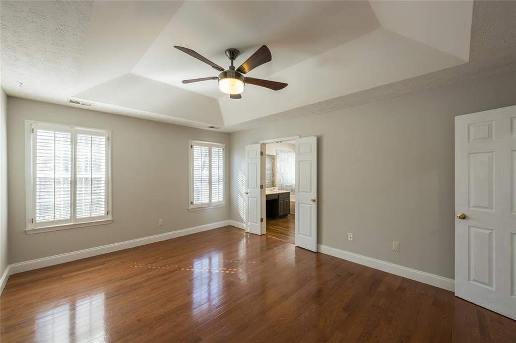 3789 Seattle Place Northwest Kennesaw, GA 30144 - Photo 25 of 40 a view of an empty room with wooden floor and a window