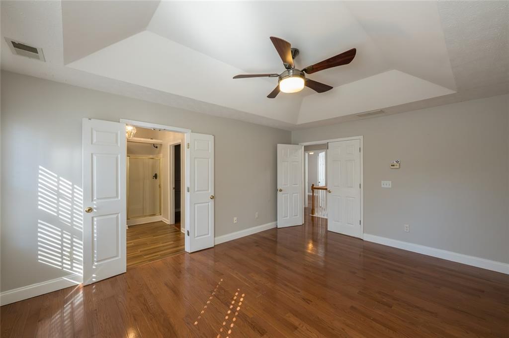 3789 Seattle Place Northwest Kennesaw, GA 30144 - Photo 26 of 40 a view of empty room with wooden floor and ceiling fan