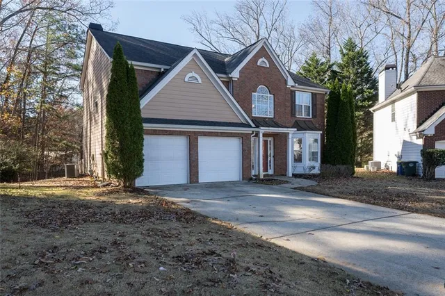a front view of a house with a road
