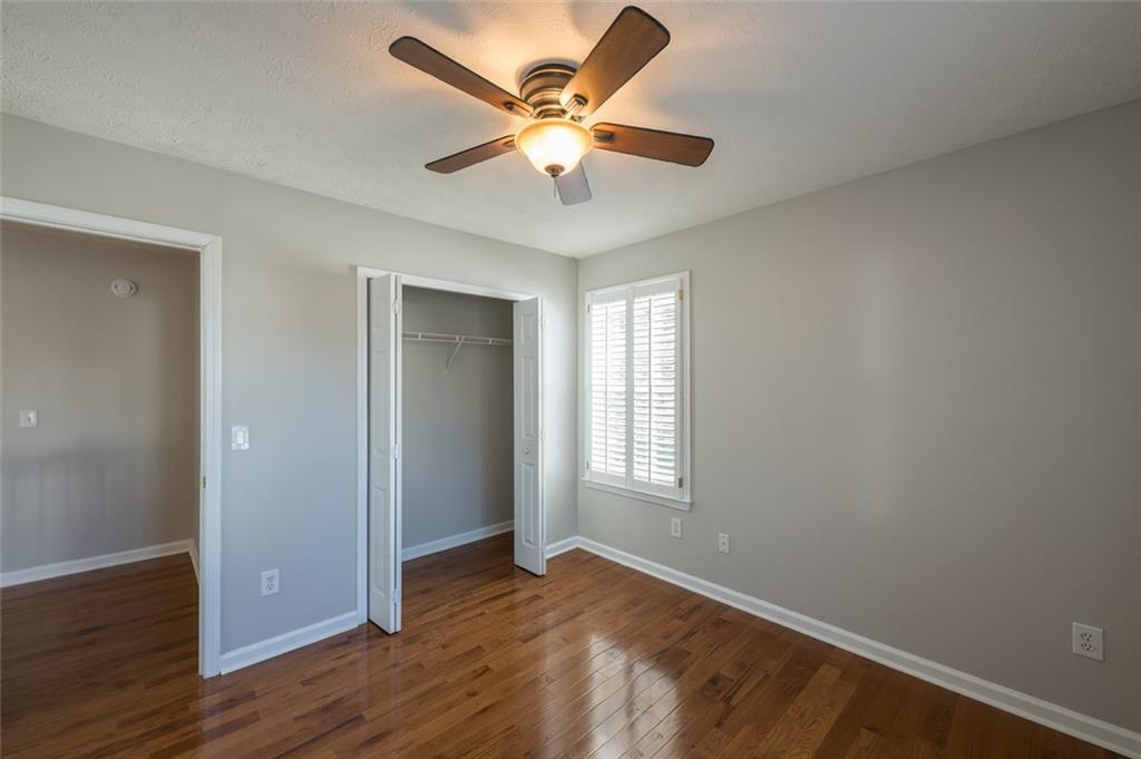 3789 Seattle Place Northwest Kennesaw, GA 30144 - Photo 31 of 40 an empty room with wooden floor and windows