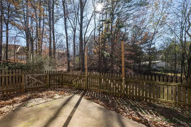 a view of a pathway with a wrought fence
