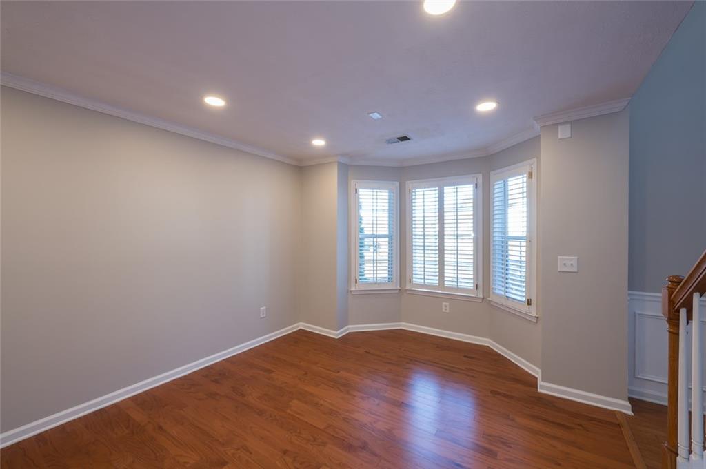 3789 Seattle Place Northwest Kennesaw, GA 30144 - Photo 6 of 40 a view of empty room with wooden floor and fan