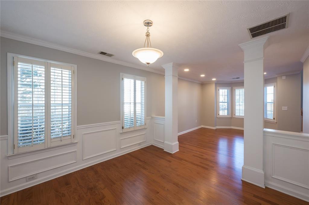 3789 Seattle Place Northwest Kennesaw, GA 30144 - Photo 8 of 40 a view of an empty room with wooden floor and a window