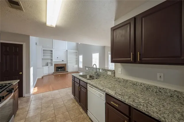 a kitchen with stainless steel appliances granite countertop a sink stove and oven