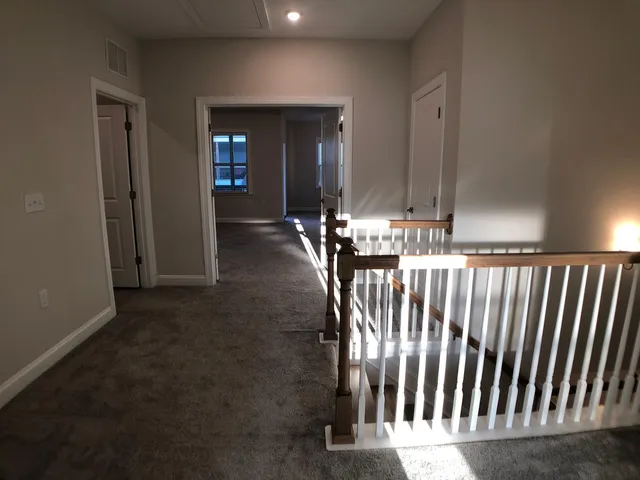 a view of a hallway with seating area