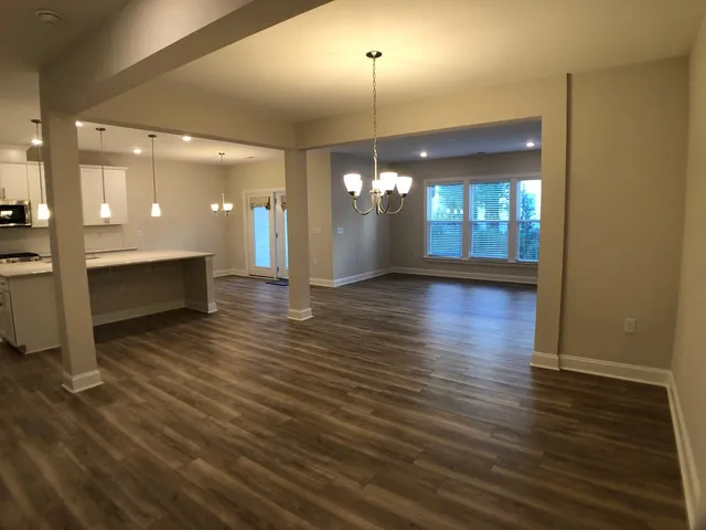 a view of a room with wooden floor and staircase