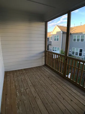 a view of a balcony with wooden floor