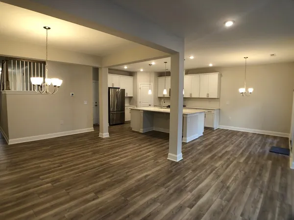 a view of a kitchen with a sink and a refrigerator