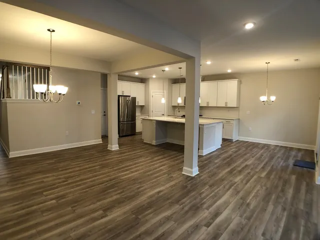a view of a kitchen with a sink and a refrigerator