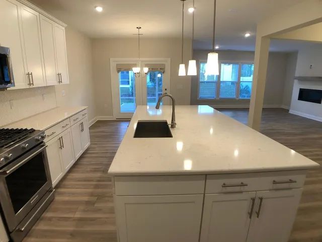 a large white kitchen with stainless steel appliances