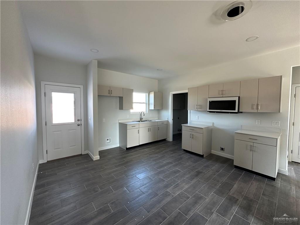 1609 Unity Drive Mercedes, TX 78570 - Photo 3 of 10 a view of a kitchen with microwave and stove