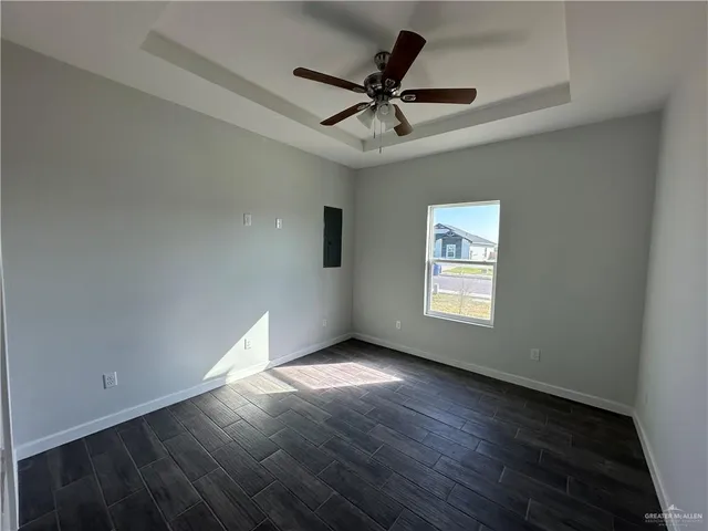 a view of wooden floor and a chandelier fan in a room