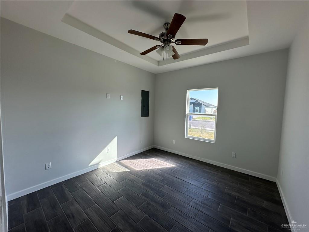 1609 Unity Drive Mercedes, TX 78570 - Photo 5 of 10 a view of wooden floor and a chandelier fan in a room