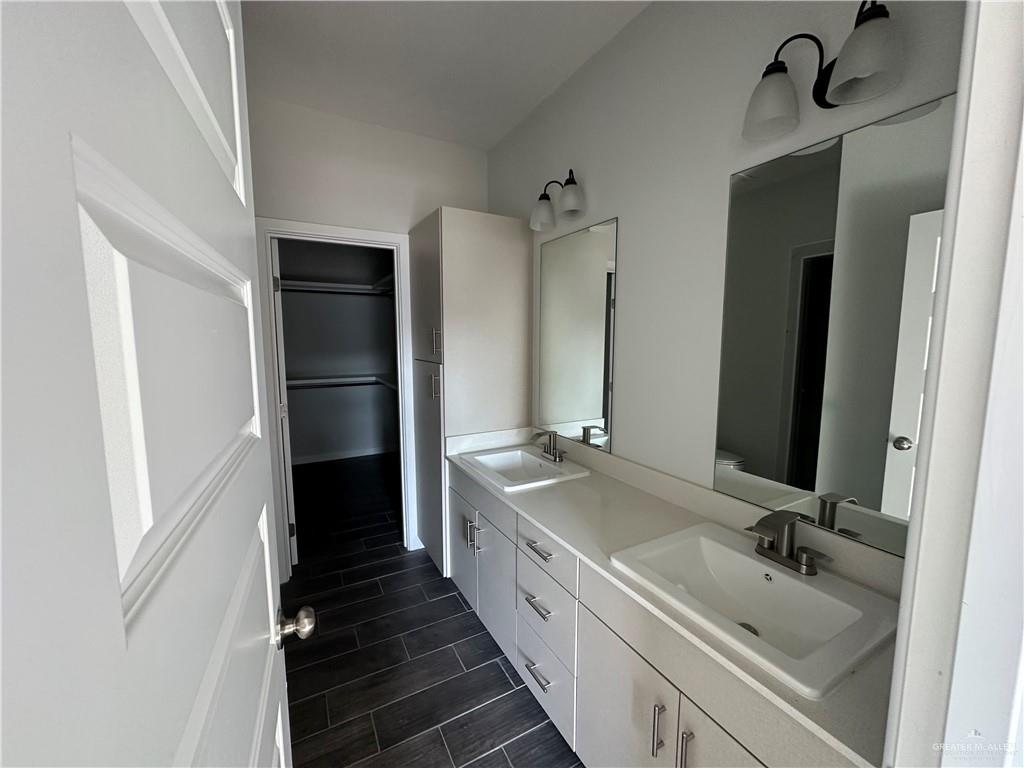1609 Unity Drive Mercedes, TX 78570 - Photo 6 of 10 a bathroom with a double vanity sink and mirror