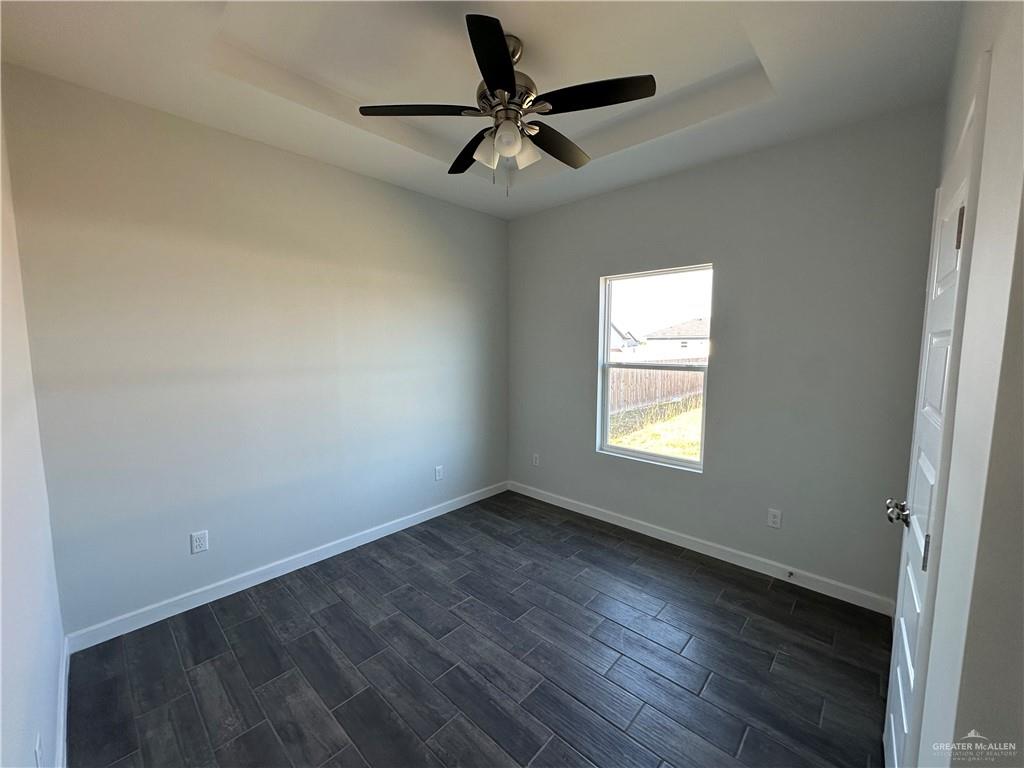 1609 Unity Drive Mercedes, TX 78570 - Photo 7 of 10 an empty room with wooden floor and windows