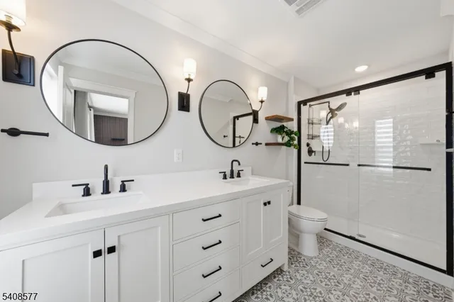 a bathroom with a toilet a sink and a mirror