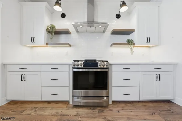 a kitchen with stainless steel appliances a stove and cabinets