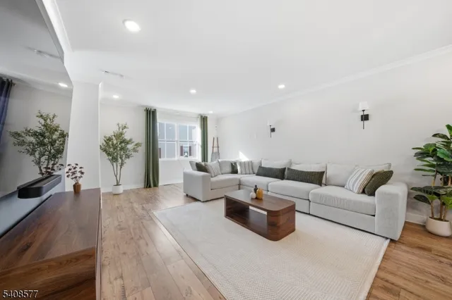 a living room with furniture potted plant and a window