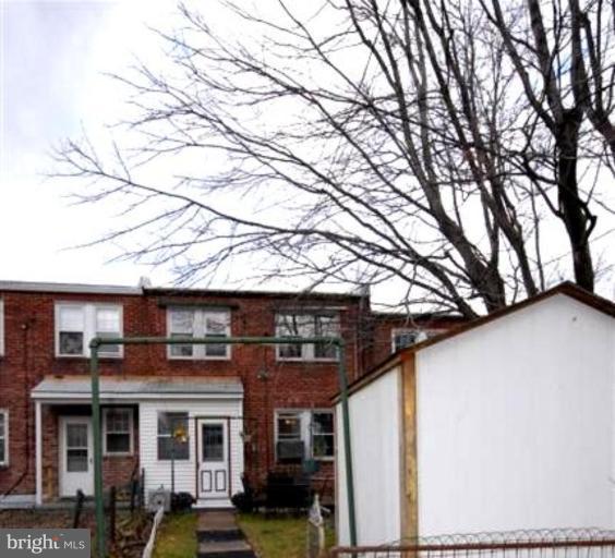 903 Calwell Road Baltimore, MD 21229 - Photo 14 of 19 a front view of a building with large trees