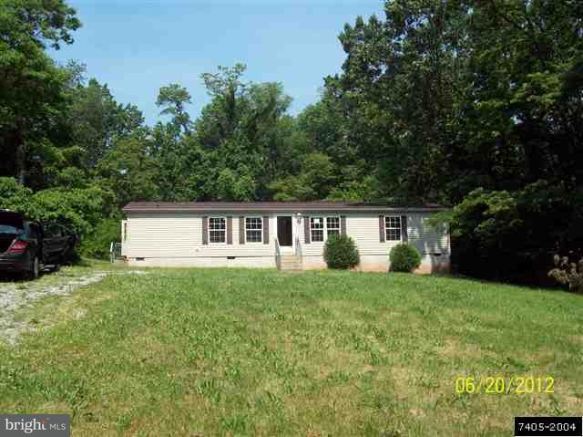 30 Hemlock Road Manchester, PA 17345 - Photo 1 of 25 a house that is sitting in the grass with large trees and plants