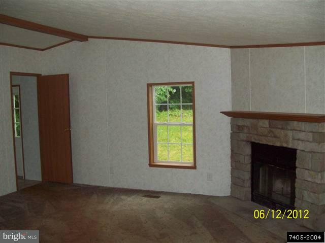 30 Hemlock Road Manchester, PA 17345 - Photo 15 of 25 a view of an empty room with a fireplace and a window