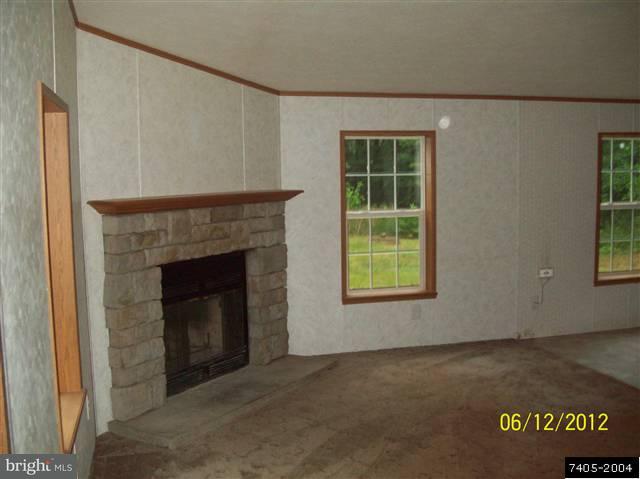 30 Hemlock Road Manchester, PA 17345 - Photo 16 of 25 a view of an empty room with a fireplace and a window