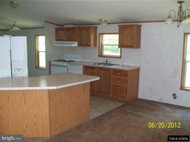30 Hemlock Road Manchester, PA 17345 - Photo 5 of 25 a kitchen with stainless steel appliances granite countertop a sink a stove and a refrigerator