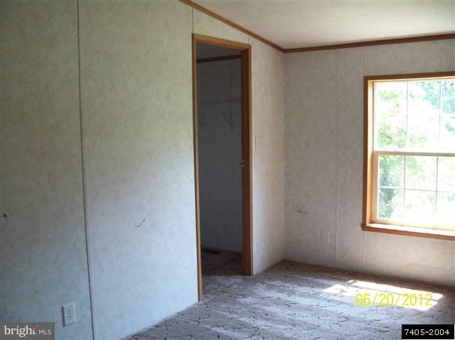 30 Hemlock Road Manchester, PA 17345 - Photo 7 of 25 a view of an empty room with wooden floor and a window
