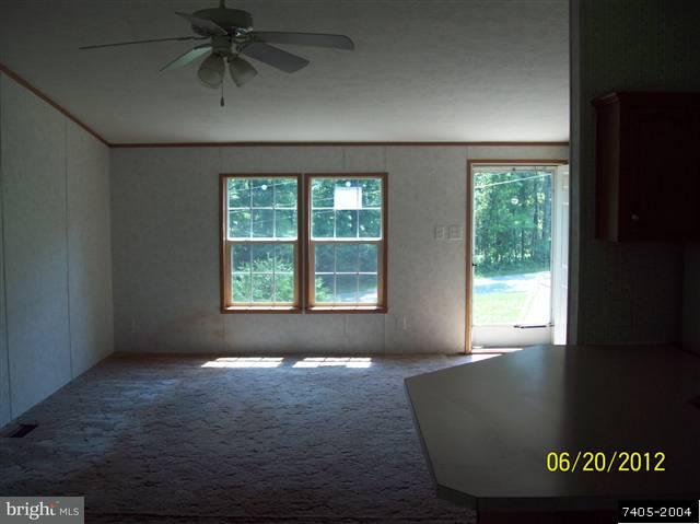 30 Hemlock Road Manchester, PA 17345 - Photo 9 of 25 an empty room with windows and ceiling fan