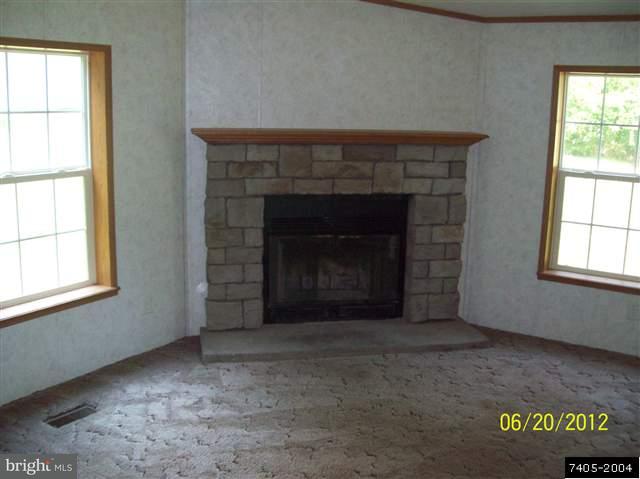 30 Hemlock Road Manchester, PA 17345 - Photo 10 of 25 an empty room with a fireplace