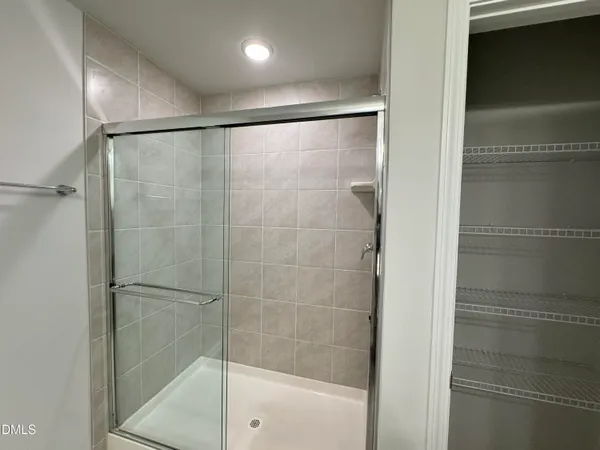 a bathroom with a glass shower door