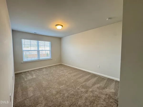 an empty room with a empty space and a window