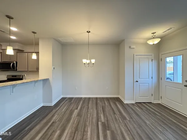 a view of a room with wooden floor and window