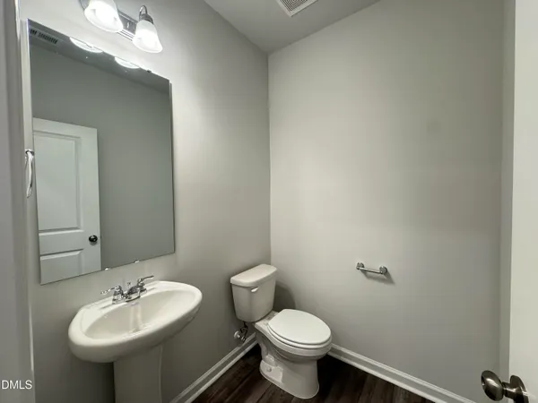 a bathroom with a sink mirror and toilet