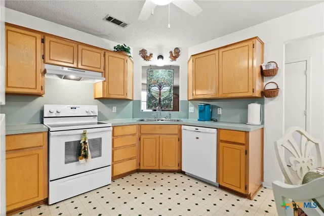 a kitchen with stainless steel appliances granite countertop a refrigerator sink and cabinets