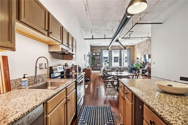 a kitchen with sink stove and cabinets