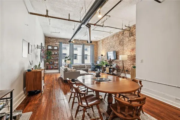 a dining room with furniture and wooden floor