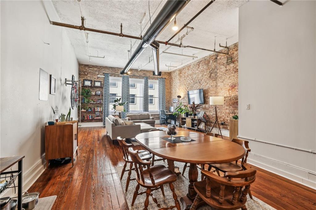 215 Mitchell Street Southwest, Unit 19 Atlanta, GA 30303 - Photo 15 of 29 a dining room with furniture and wooden floor