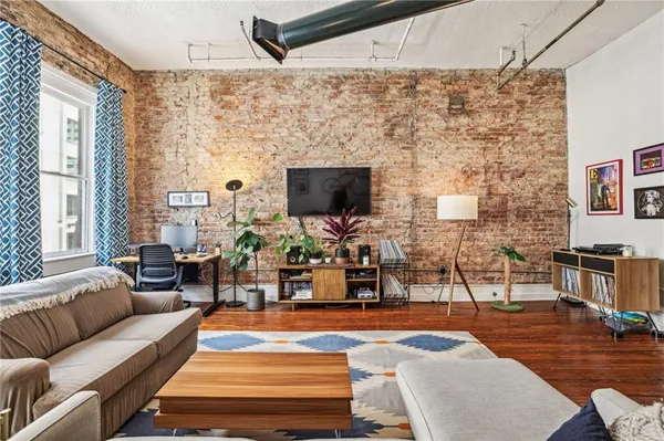 a living room with patio furniture and a flat screen tv