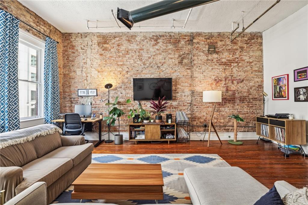 215 Mitchell Street Southwest, Unit 19 Atlanta, GA 30303 - Photo 17 of 29 a living room with patio furniture and a flat screen tv