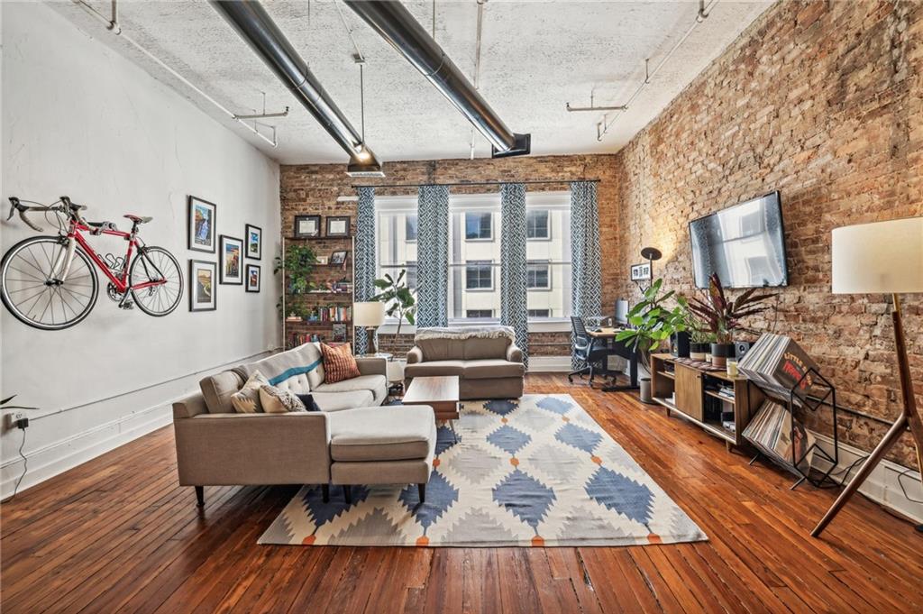 215 Mitchell Street Southwest, Unit 19 Atlanta, GA 30303 - Photo 20 of 29 a living room with furniture and a wooden floor