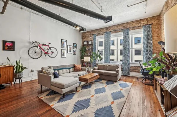 a living room with furniture and wooden floor
