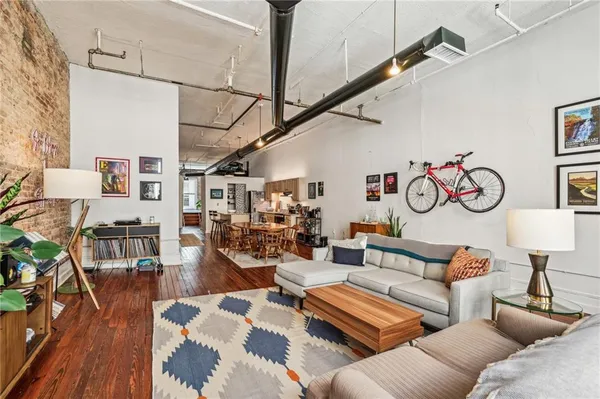 a living room with furniture and wooden floor