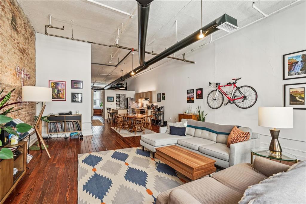 215 Mitchell Street Southwest, Unit 19 Atlanta, GA 30303 - Photo 22 of 29 a living room with furniture and wooden floor
