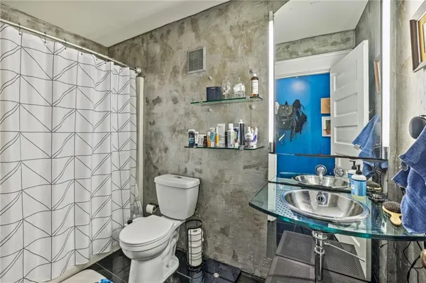 a bathroom with a toilet a sink and a shower