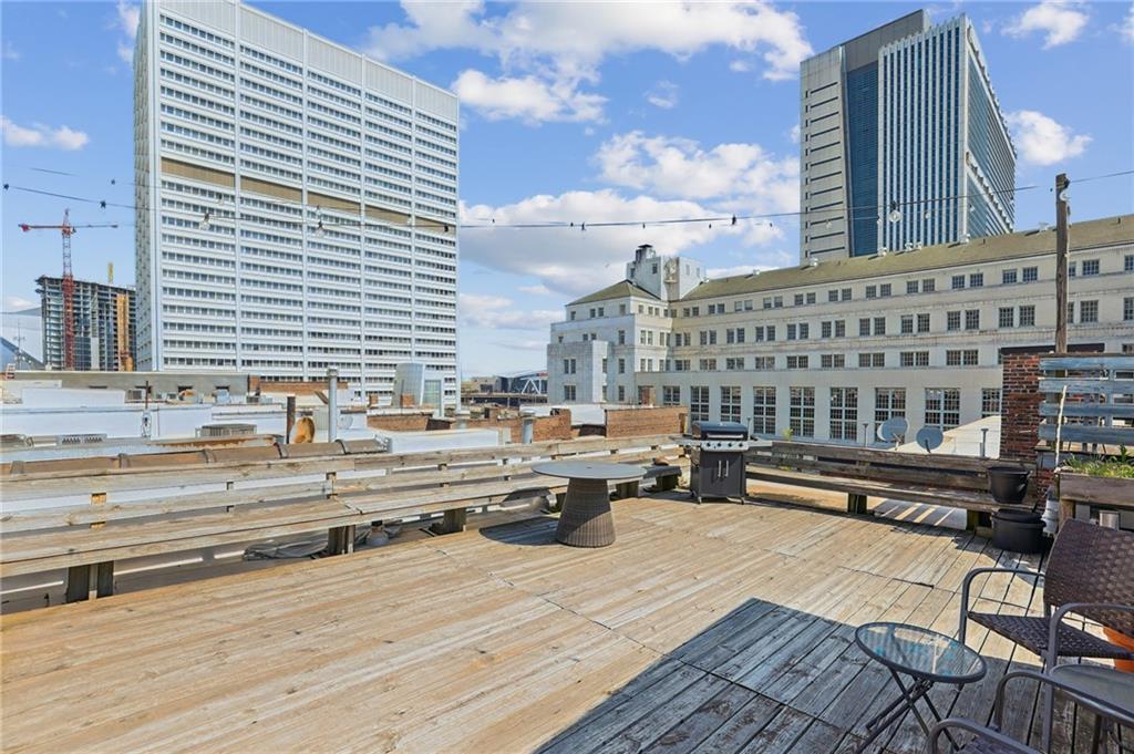 215 Mitchell Street Southwest, Unit 19 Atlanta, GA 30303 - Photo 25 of 29 a view of a balcony with chairs and wooden floor