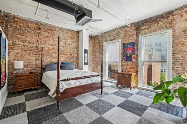 a bed sitting in a bedroom next to a window