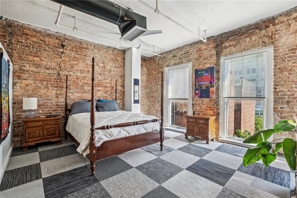 215 Mitchell Street Southwest, Unit 19 Atlanta, GA 30303 - Photo 5 of 29 a bed sitting in a bedroom next to a window