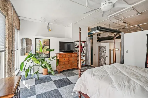 a bed room with furniture and a flat screen tv